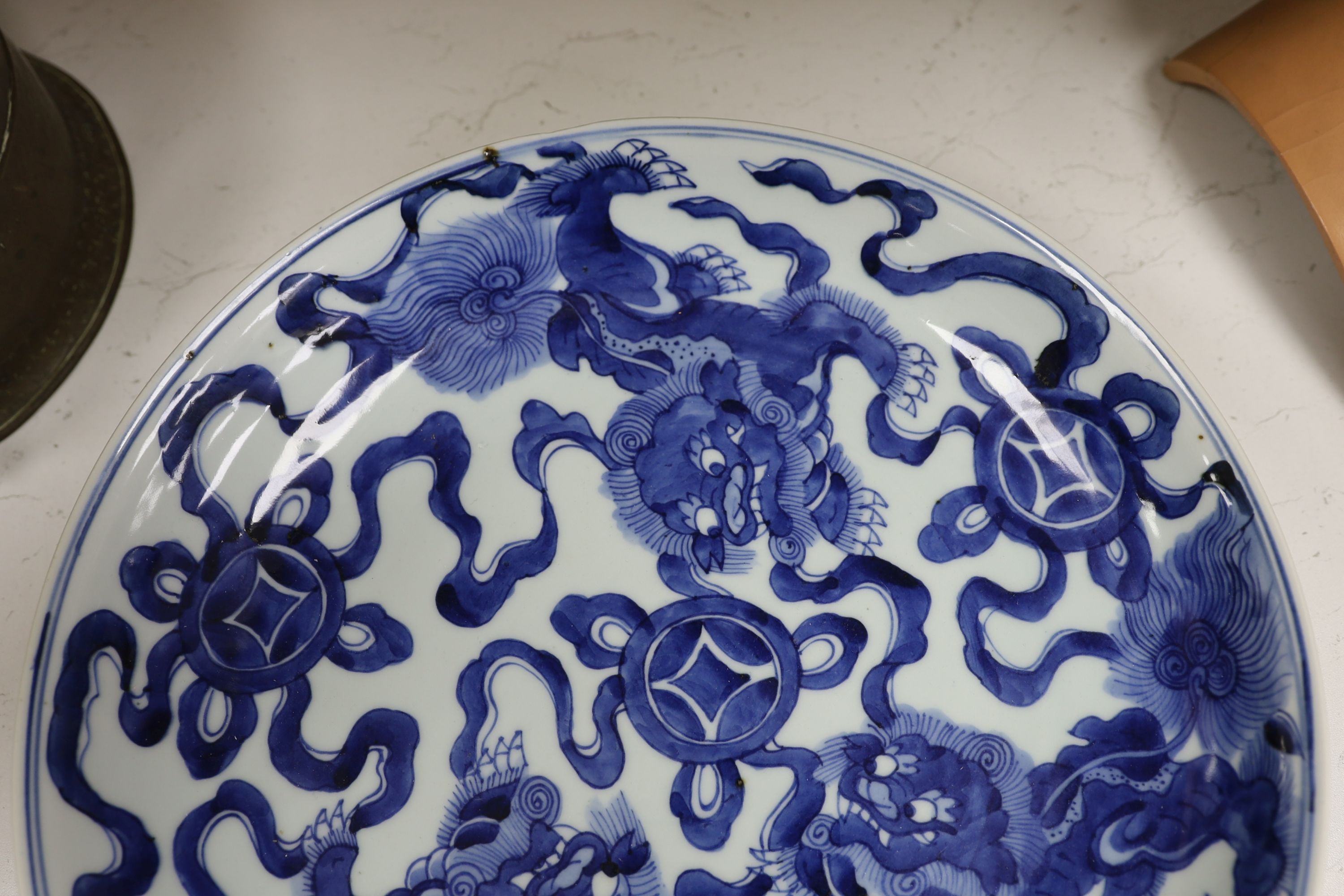 A Chinese blue and white ‘Buddhist lion’ dish, channel moulded foot, 36cm diameter